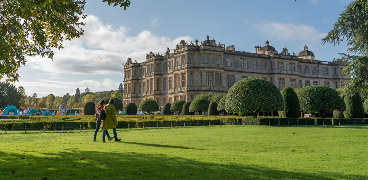 Visitors walking on the lawn outside Longleat House