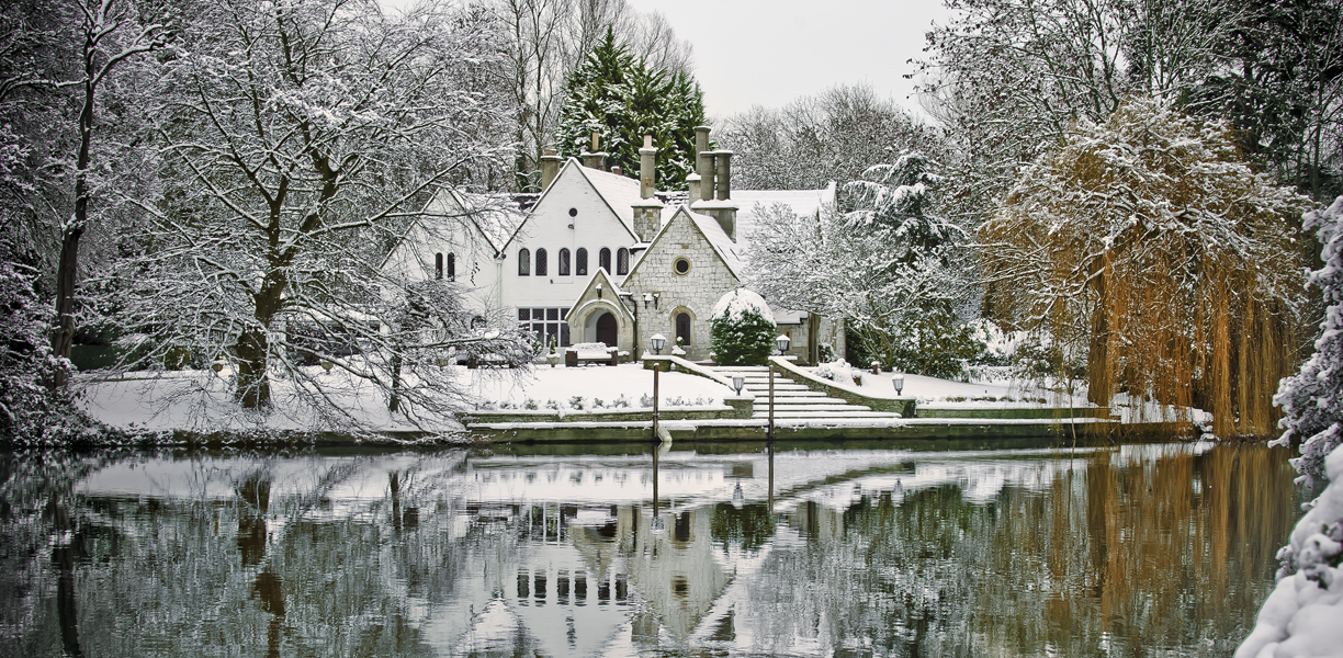 A snowy house by the river at Runnymede