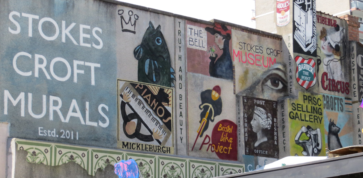 A wall covered in street art in Bristol