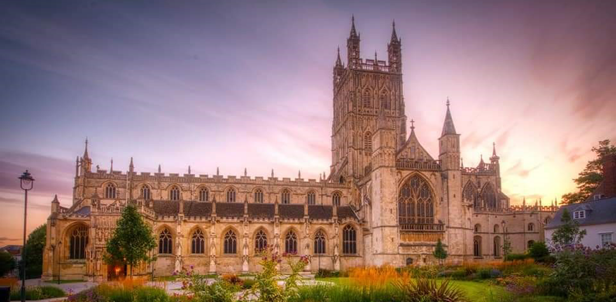 sun setting behind gloucester cathedral