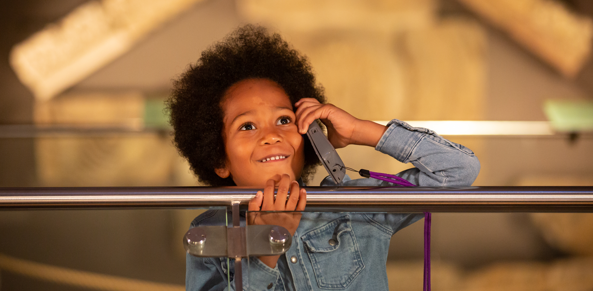 Child listening to audio guide