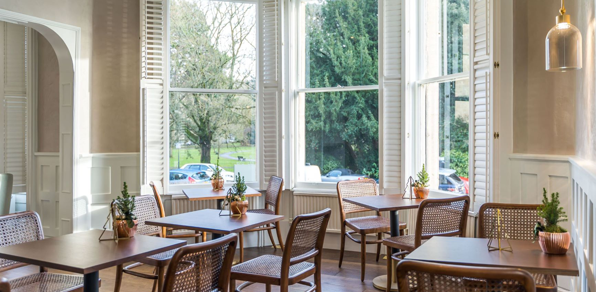 tables set up for breakfast by windows