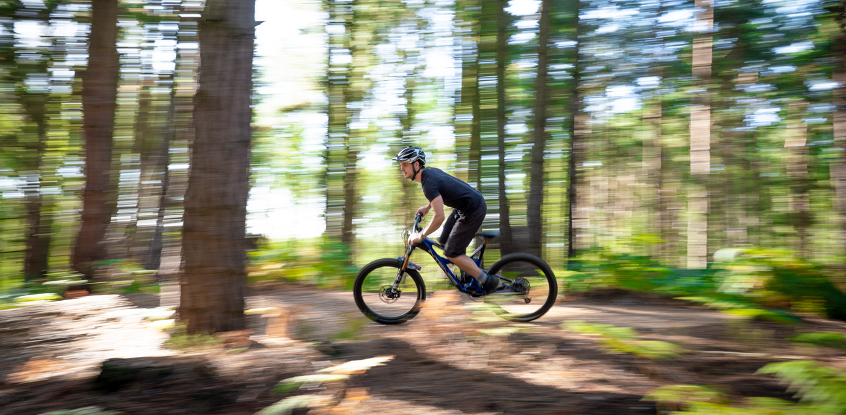 Man riding a bike amongst the trees