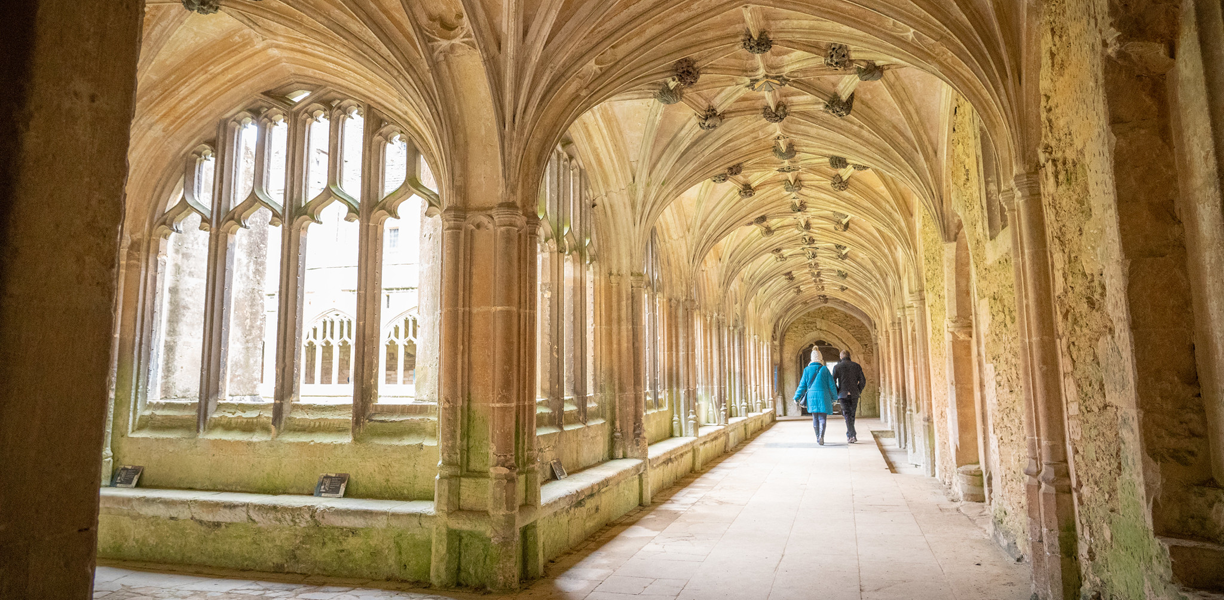 people walking in abbey cloister